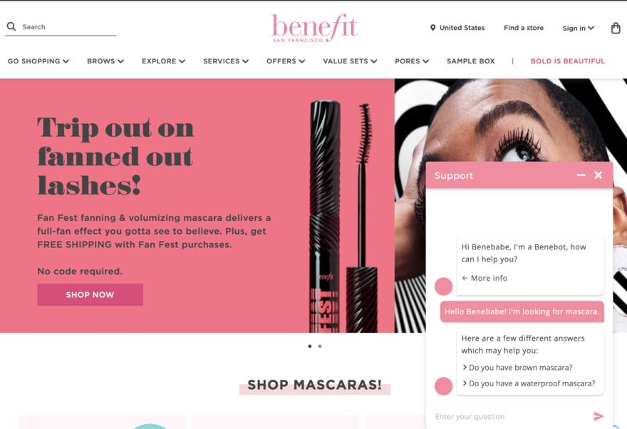 A bright website with Benefit cosmetics. On the left is a pink block with mascara on, on the right is a close-up of a beautiful Black woman's face, and a live chat pop-up.
