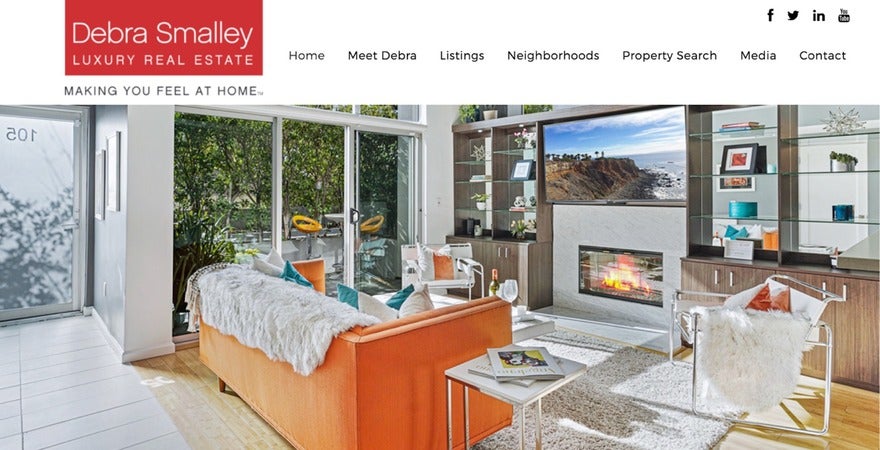 Web banner for Debra Smalley Luxury Real Estate showcasing an elegant interior with a view of a hillside, embodying the comfort and style of high-end living.