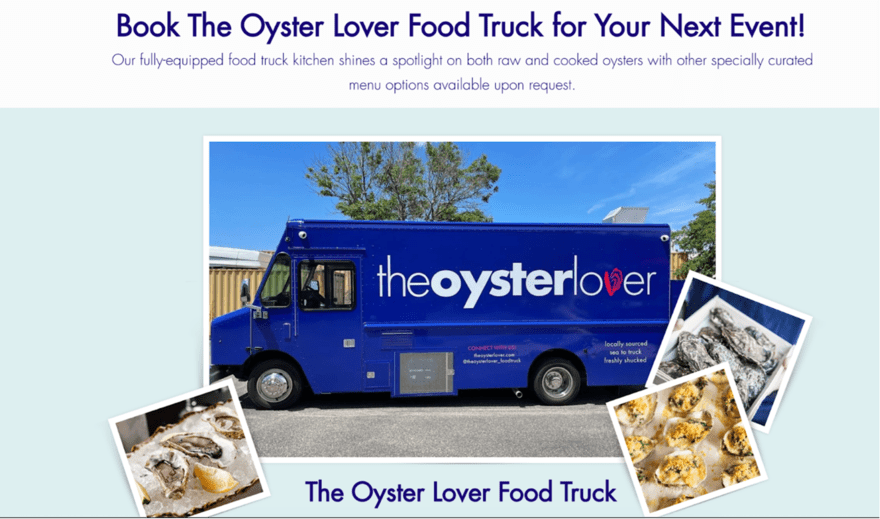 A blue food truck parked next to a tree. The truck has a large sign on the side that says "The Oyster Lover Food Truck." The sign also has a picture of an oyster on it.