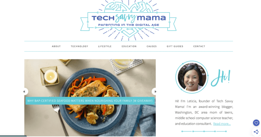A blog header for "Tech Savvy Mama," focused on parenting in the digital age. The navigation bar includes About, Technology, Lifestyle, Education, Causes, Gift Guides, and Contact. There's a greeting from Leticia, the founder, alongside her photo and a brief intro about her background as a blogger, mother, teacher, and consultant. The featured article discusses the importance of BAP-certified seafood for family nutrition, with an image of a cooked fish dish.